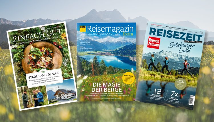 Drei Salzburger Reisemagazine vor einer malerischen Berg- und Wildblumenlandschaft.
